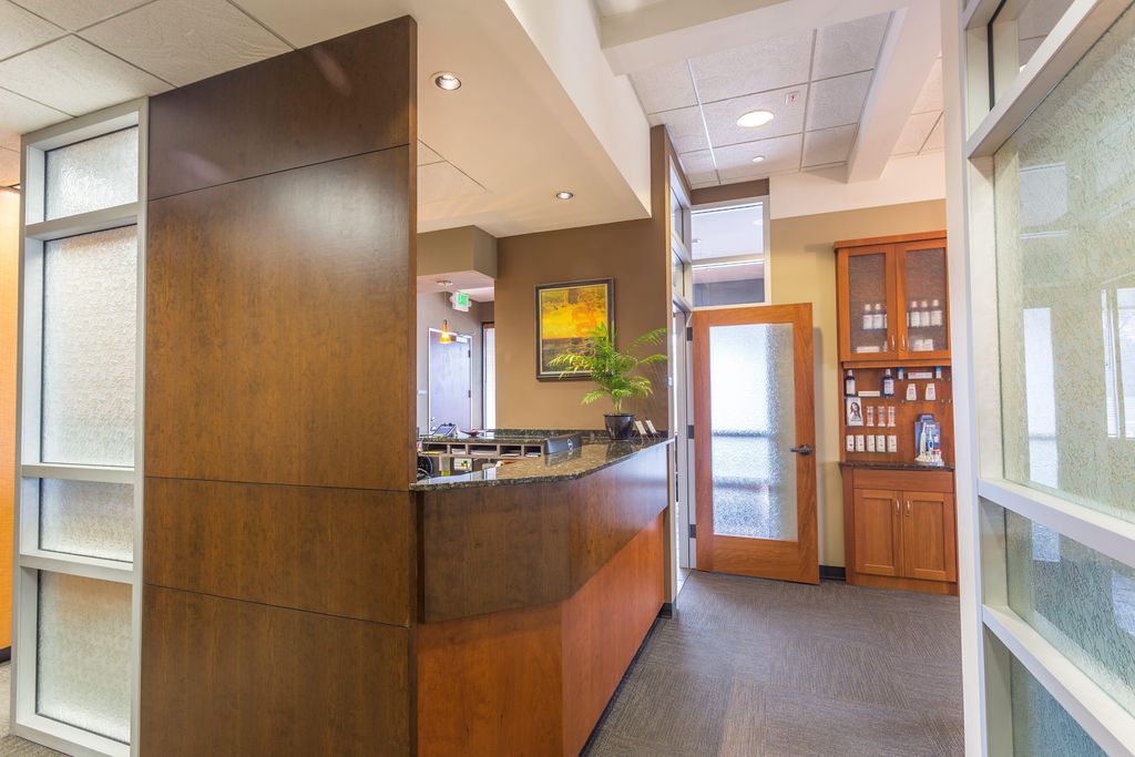 The front desk and reception counter at the office, in wood and granite